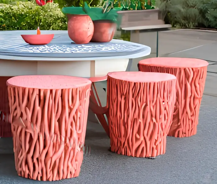 Unique garden stool ideas - three coral garden stools around a patio table